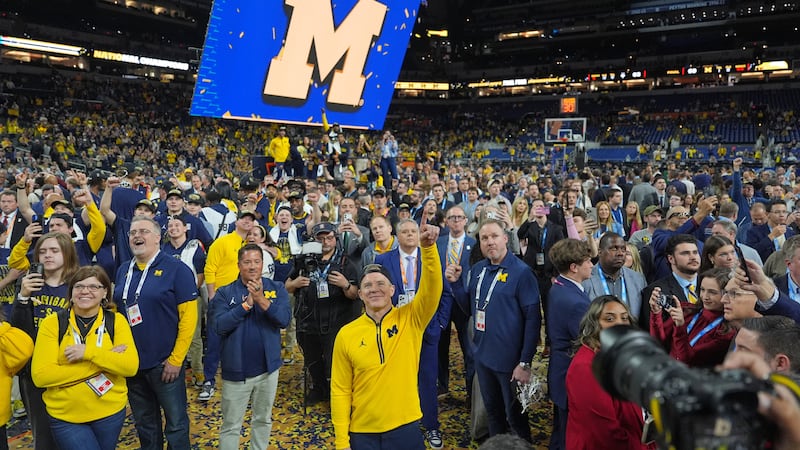FILE - Michigan head coach Dusty May celebrates after defeating UConn in the NCAA college...