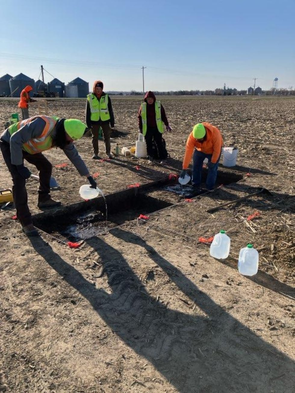 Watering the dirt to enable digging. Evaporation from strong winds combined hardens dirt....
