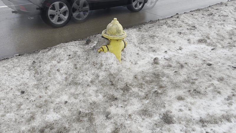 As residents clear snow from their property after a snowstorm, Sioux ...